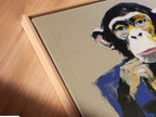 A close up of the canvas print in a floating frame. The floating frame enhances the modern look of the artwork. It provides a clean and sophisticated display. The business monkey art print is perfect for adding a contemporary touch to any office space.