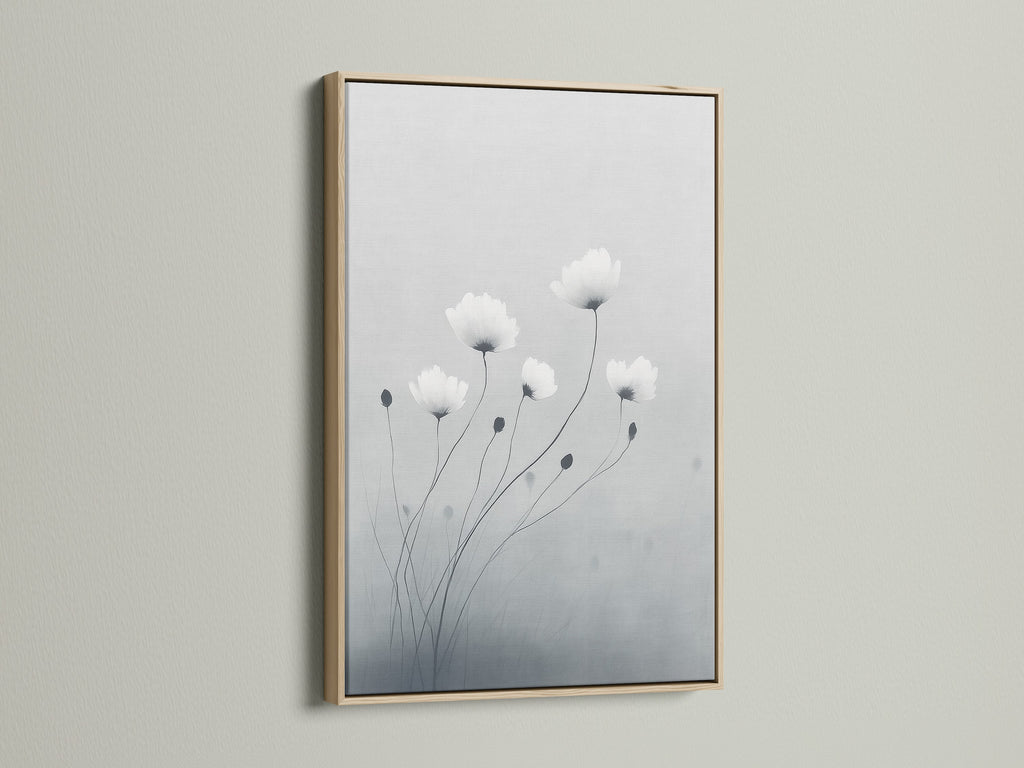 This minimalist flower artwork is framed in oak. The soft gray and white botanical print offers a serene touch. It enhances bedroom decor or any space needing a modern canvas art piece. Oak frames add a natural element and elevate minimalist wall art.