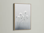 This minimalist flower artwork is framed in oak. The soft gray and white botanical print offers a serene touch. It enhances bedroom decor or any space needing a modern canvas art piece. Oak frames add a natural element and elevate minimalist wall art.