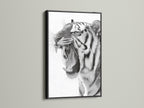 A black frame encases a captivating tiger artwork. The bold black frame creates a dramatic contrast. It enhances the visual impact of the art. Ideal for making a statement in your living space. Elevate your decor with this striking combination.