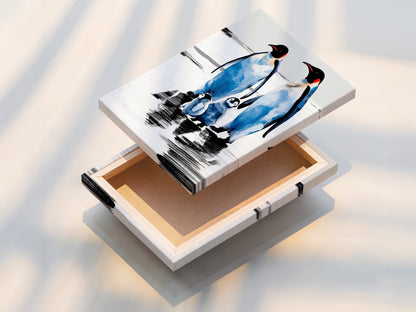 Stretched canvas print of a penguin family. This coastal wall decor is perfect for nurseries. The arctic wildlife canvas art makes a great gift for animal lovers. A blue and white winter wall art piece.