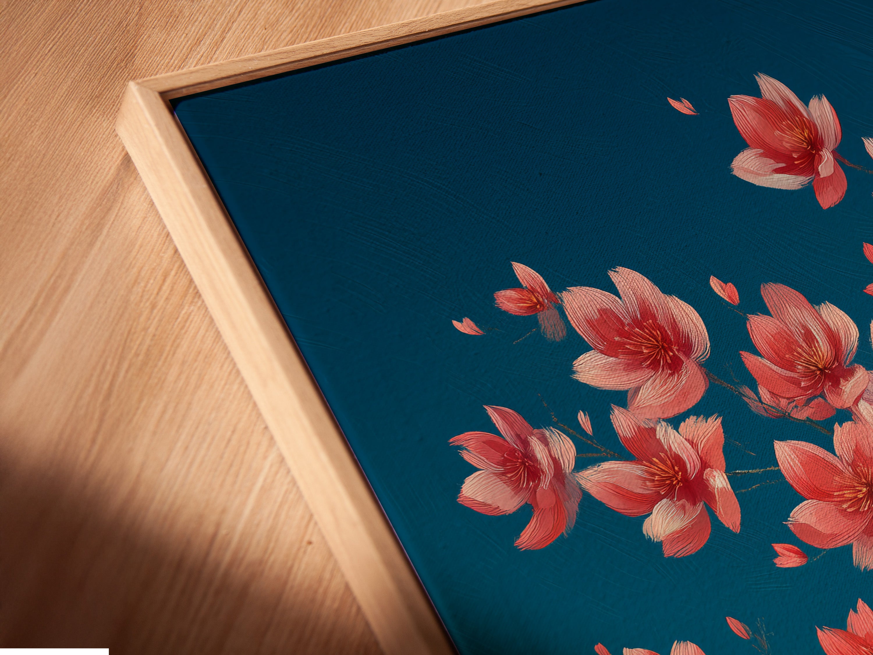 Close-up of a canvas print in a floating frame. The artwork features a cherry blossom tree with teal and pink hues. This modern framing style adds depth to your floral wall decor. Perfect for a bedroom or living room.