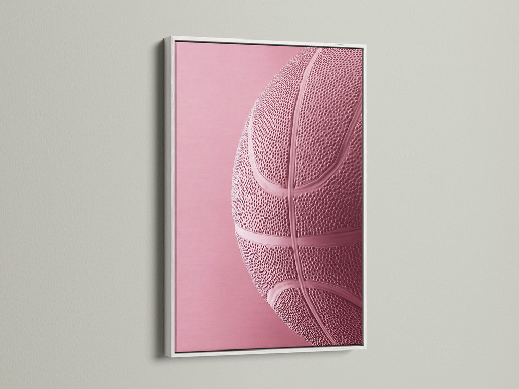 White frame on display. This frame showcases a pink basketball art print. The white frame offers a clean modern look. Its ideal for various interior styles. Transform your artwork with this frame.