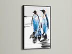 A family of penguins in a black frame. This bird art print is a unique piece of coastal decor. Perfect for homeowners renters and parents seeking distinctive wall art for living rooms bedrooms or nurseries.
