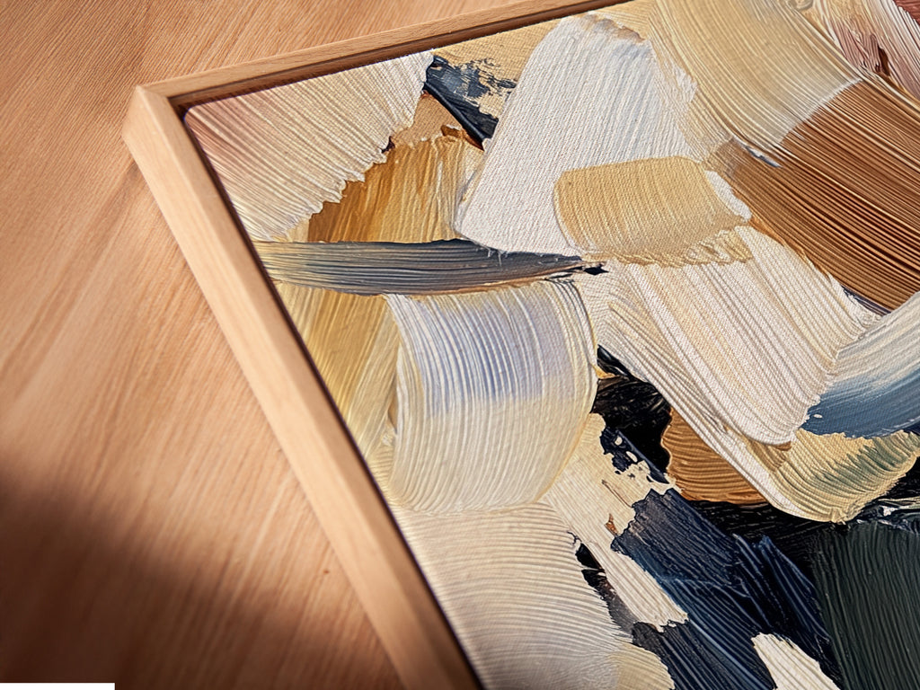 Close-up of a canvas print in a floating frame. The artwork is abstract with beige brown blue and green brushstrokes. The floating frame adds depth. Get a unique look with canvas prints in floating frames. Transform your walls with art.