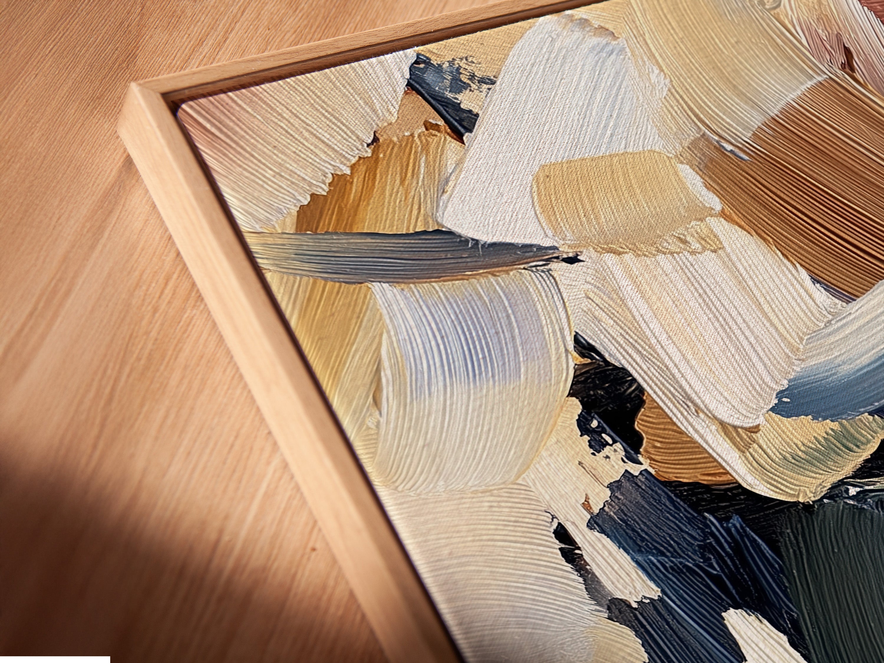 Close-up of a canvas print in a floating frame. The artwork is abstract with beige brown blue and green brushstrokes. The floating frame adds depth. Get a unique look with canvas prints in floating frames. Transform your walls with art.