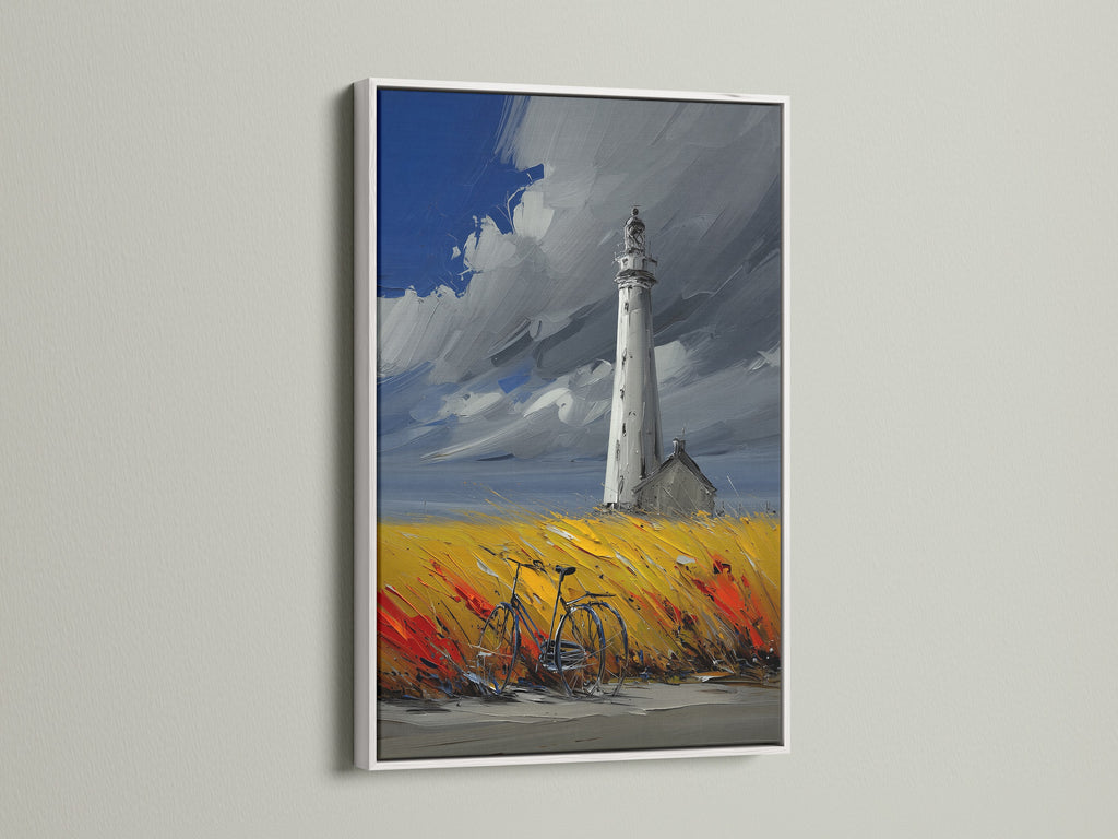 Lighthouse coastal artwork with a white frame. This seascape artwork is ideal for creating a serene atmosphere.  Great for living room wall art or bedroom wall decor. The artwork features a lighthouse in a field of yellow and red. A bicycle is parked nearby. The sky is a mix of blue and grey.