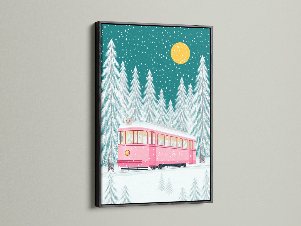 Elegant artwork displaying a pink tram in a snowy forest scene. The artwork is encased in a sleek black frame. This piece offers a modern touch to your holiday art collection. Consider it for a stylish Christmas gift.