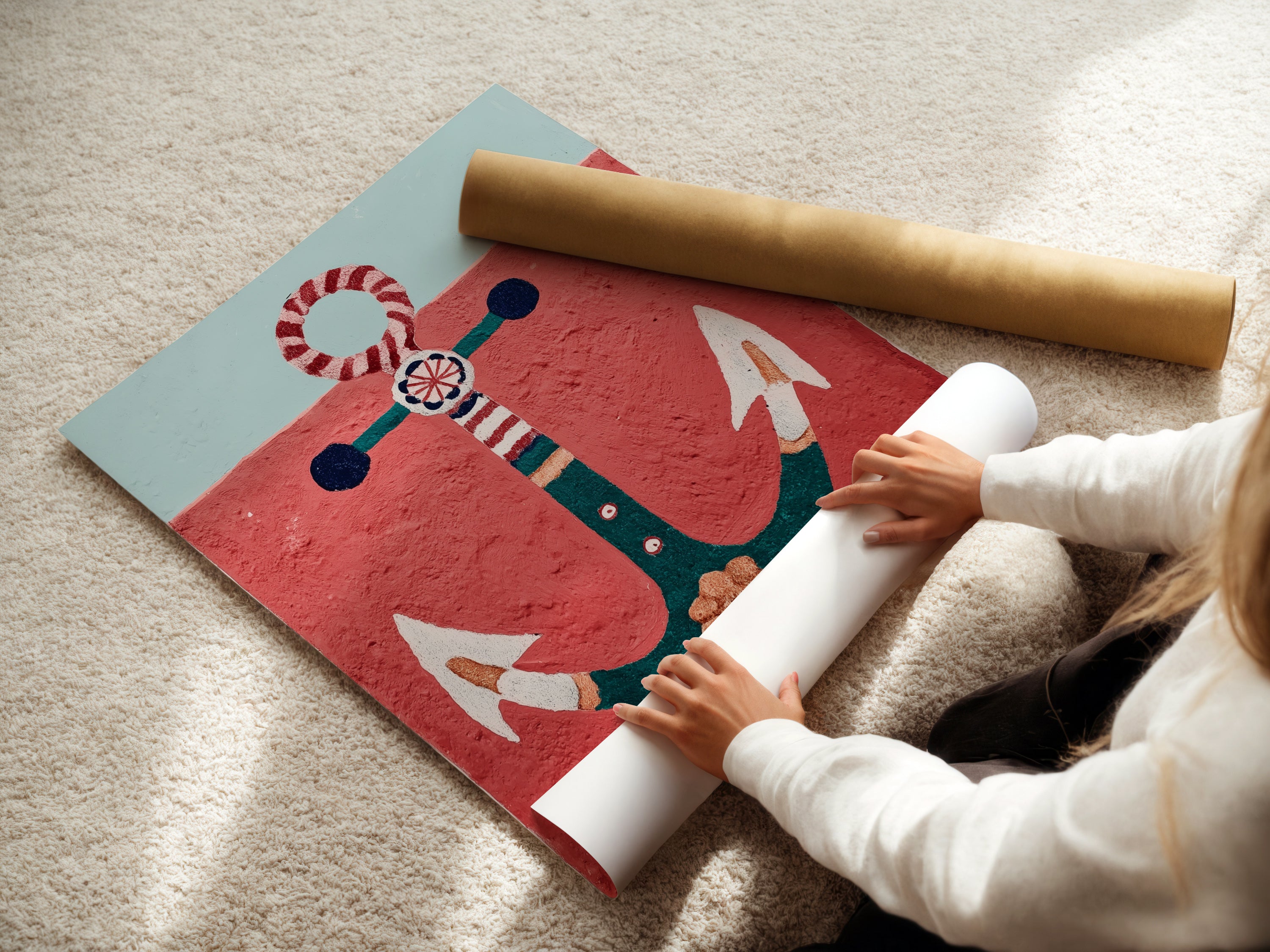 Woman rolling a fine art poster paper featuring anchor artwork. The nautical wall art is perfect for coastal decor. This red and teal art enhances any space. Ideal for vacation homes and seaside decor. Create a beach house vibe with this ocean canvas. Perfect for nautical prints.