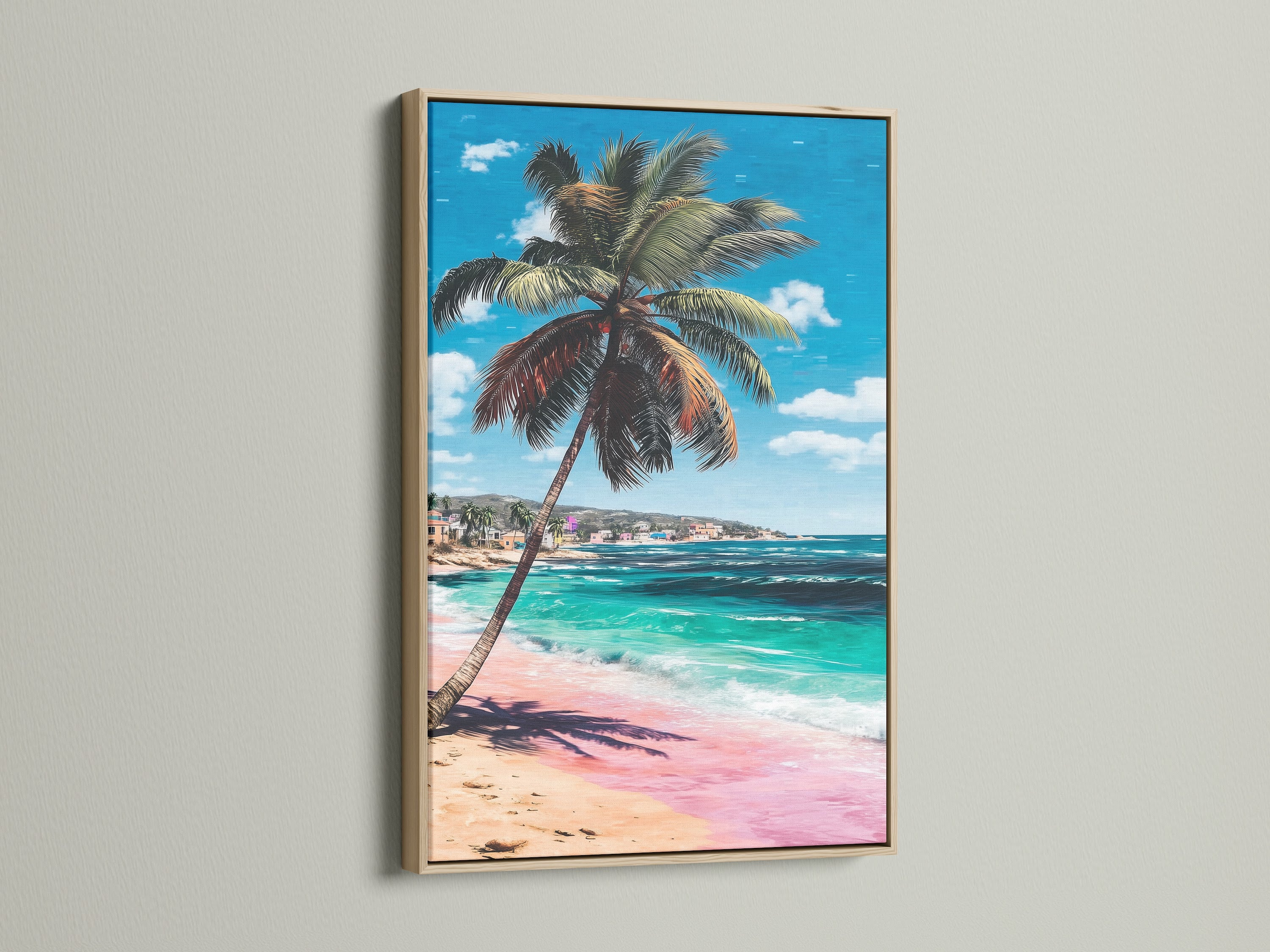 Tropical palm tree artwork showcased in an oak frame. The coastal wall art captures a serene beach scene with turquoise water and pink sand. It's perfect for adding a beachy touch to your home decor.
