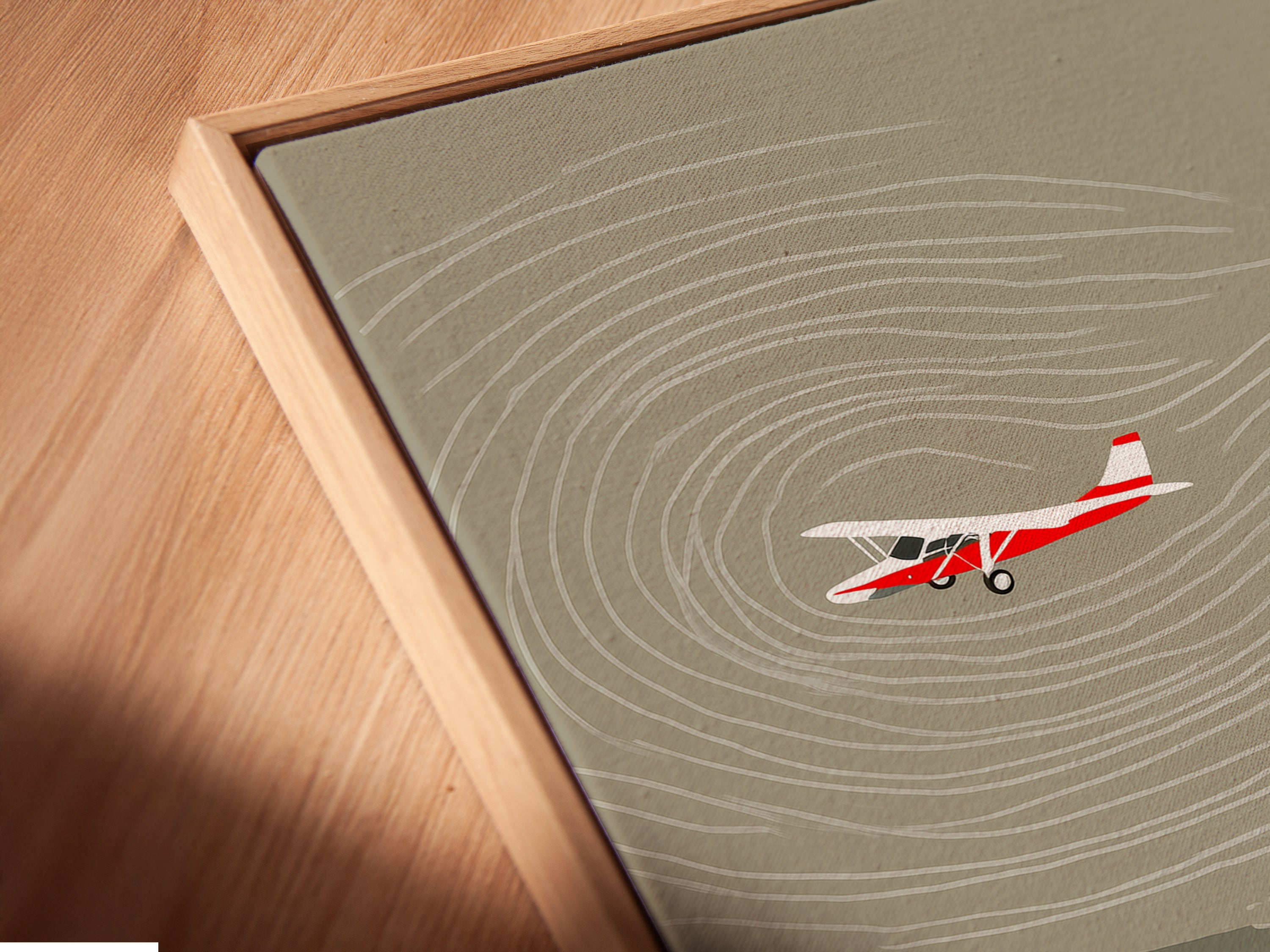 A close-up shot captures a canvas print with a floating frame. The fishing landscape artwork is a cabin canvas. The airplane print creates vintage decor for a man cave. The frame enhances the art's rustic appeal.