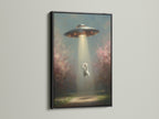 The UFO Cat art print is showcased in a black frame. This striking contrast emphasizes the surreal canvas art. The black frame adds a bold touch to your wall decor.