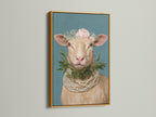Framed whimsical sheep artwork with a floral crown and pearl necklace. This Country Wall Art is displayed in a gold frame. Perfect Farm Animal Print for Nursery Wall Decor. The gold frame adds elegance to this botanical sheep art.