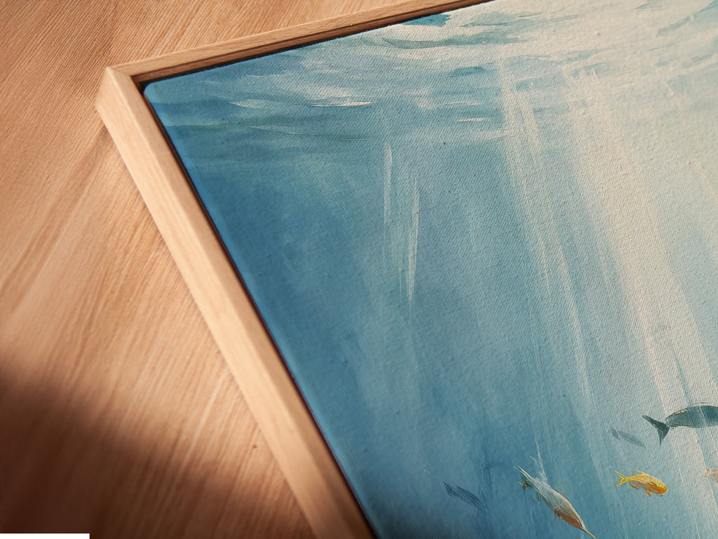 A close-up angled view of a canvas print in a floating frame. The underwater artwork depicts an ocean scene. This sea life wall art adds a coastal touch. The aqua blue painting enhances any room.