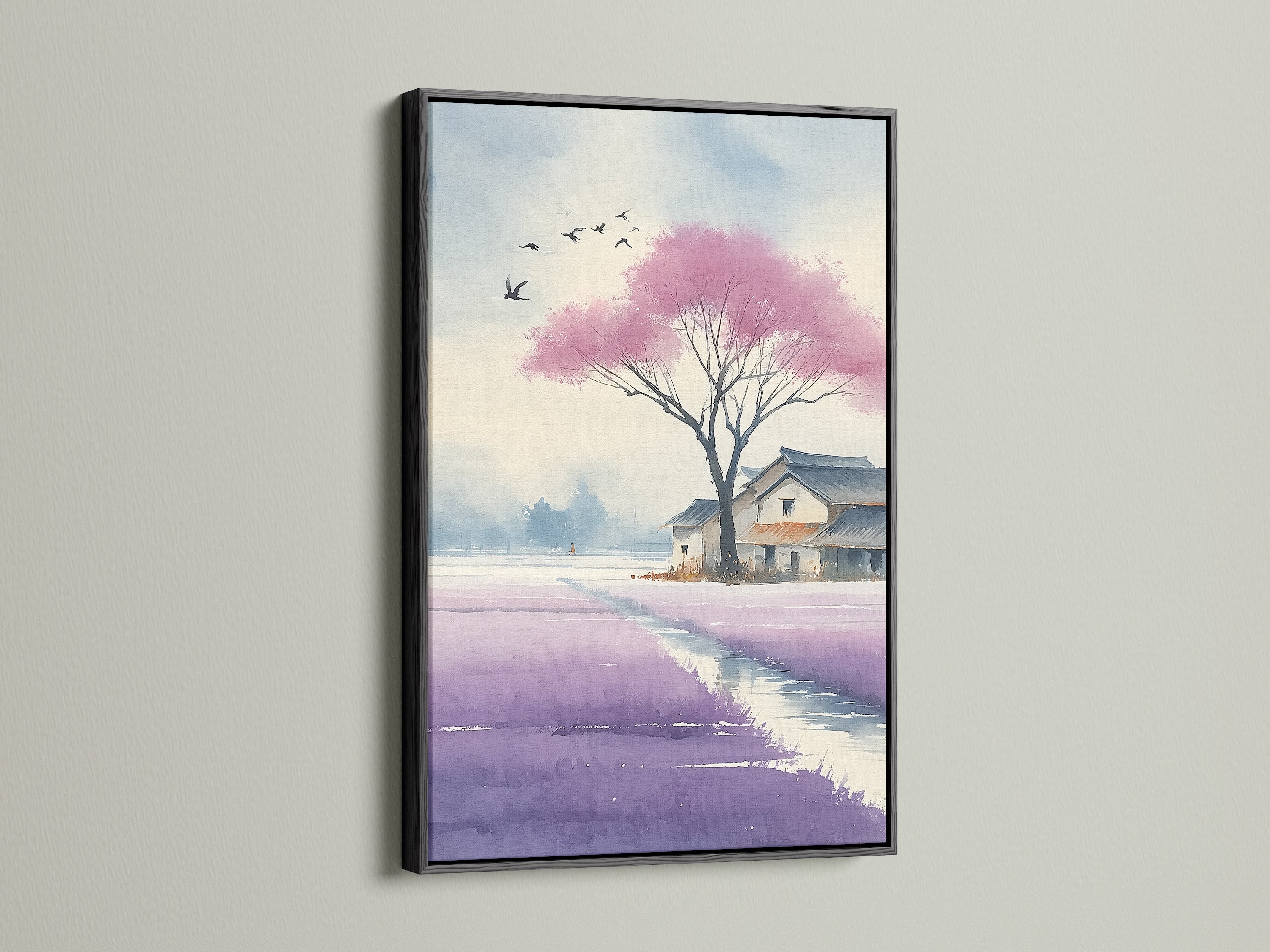 A Black framed Japanese Cherry Blossom artwork is displayed on a white wall. The watercolor canvas showcases a violet lavender field. This serene artwork brings tranquil vibes to any space. Ideal for homeowners and interior decorators seeking zen decor.