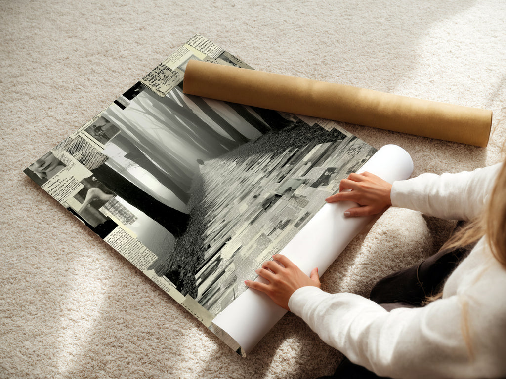 A woman carefully rolls a fine art poster paper of the Foggy Forest Path. This black and white collage wall art is ready to be framed and displayed. Perfect for adding a touch of mystery to your study room. This monochrome print enhances modern minimalist and Scandinavian interiors.