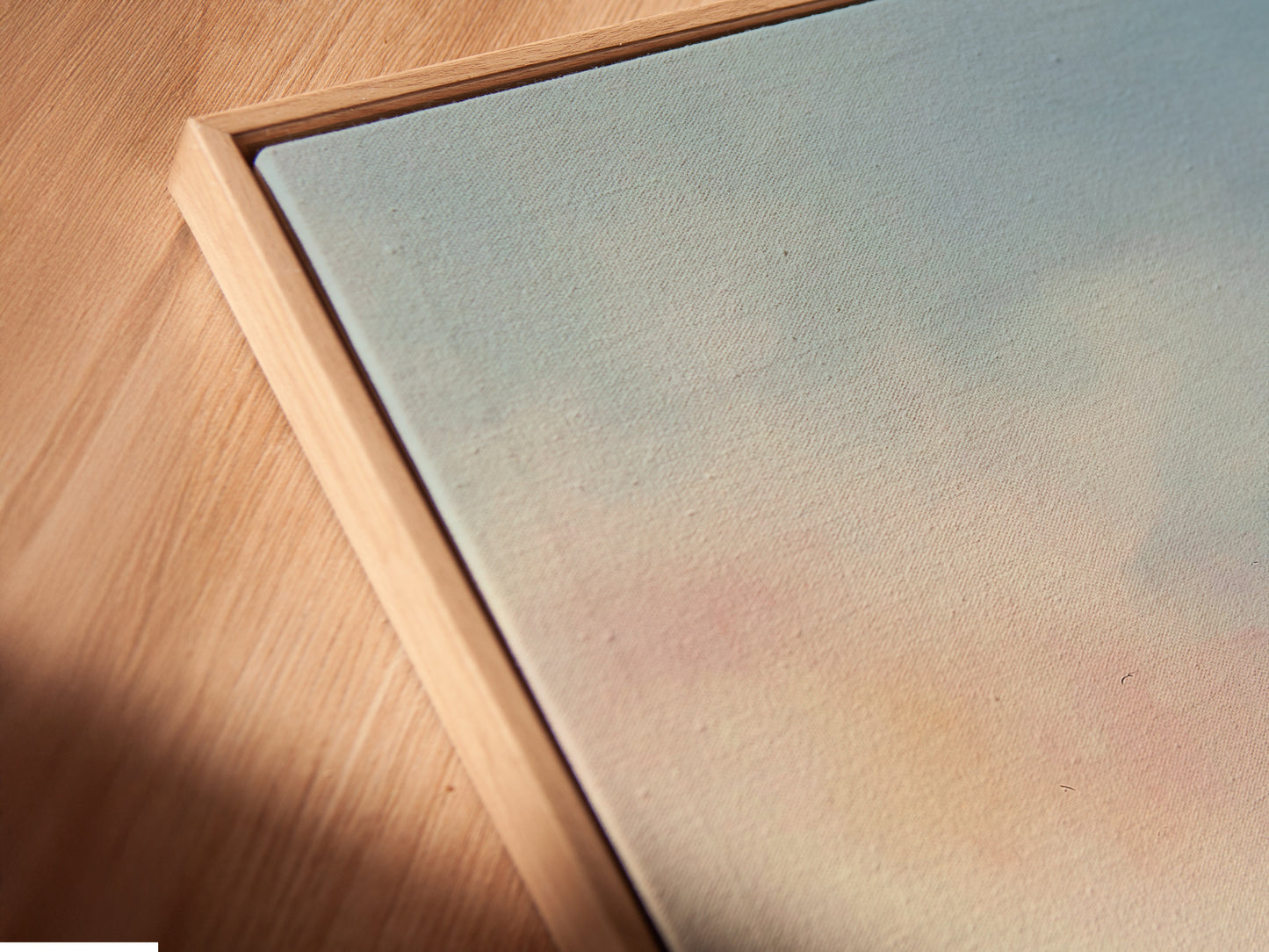 A close-up of a cargo ship canvas print in a floating frame. The artwork appears to hover adding a modern touch. This nautical wall art enhances any space. The floating frame accentuates the artwork's depth and detail creating a stunning visual effect.