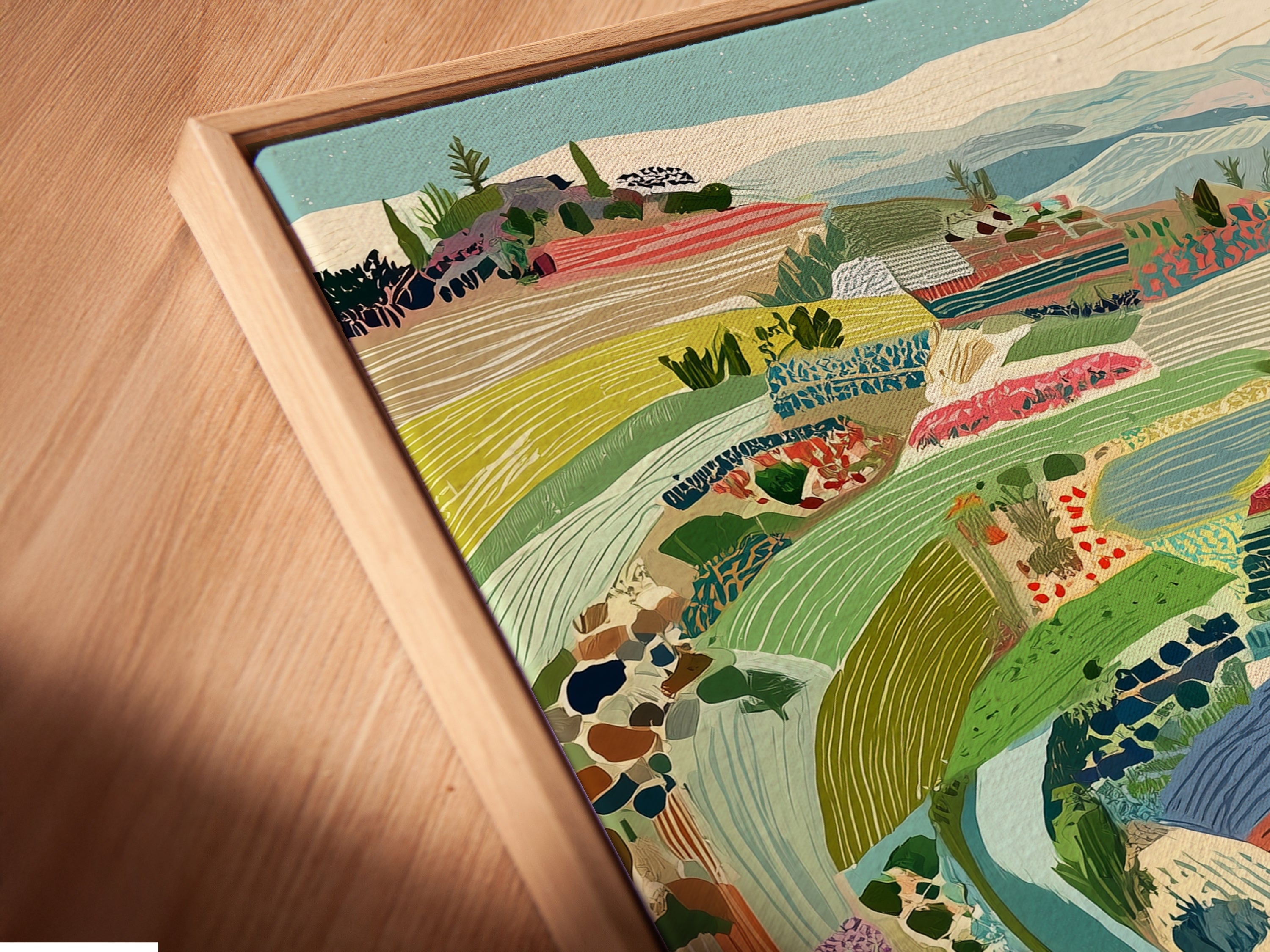 Angled close up view of a canvas print in a floating frame. The artwork is an Italian Landscape. The Tuscan countryside is the perfect farmhouse wall art. A colorful artwork for your kitchen.