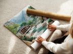 A woman is carefully rolling a fine art poster paper featuring the Zen Garden artwork. The poster showcases an Asian landscape. Perfect for serene mountain views. This calming scenery brings peace to any space.