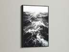 A black frame displays black and white ocean wave artwork. This classic frame creates a dramatic effect. Ideal for monochrome art and ocean photography. Enhance your living room wall art today explore our options.