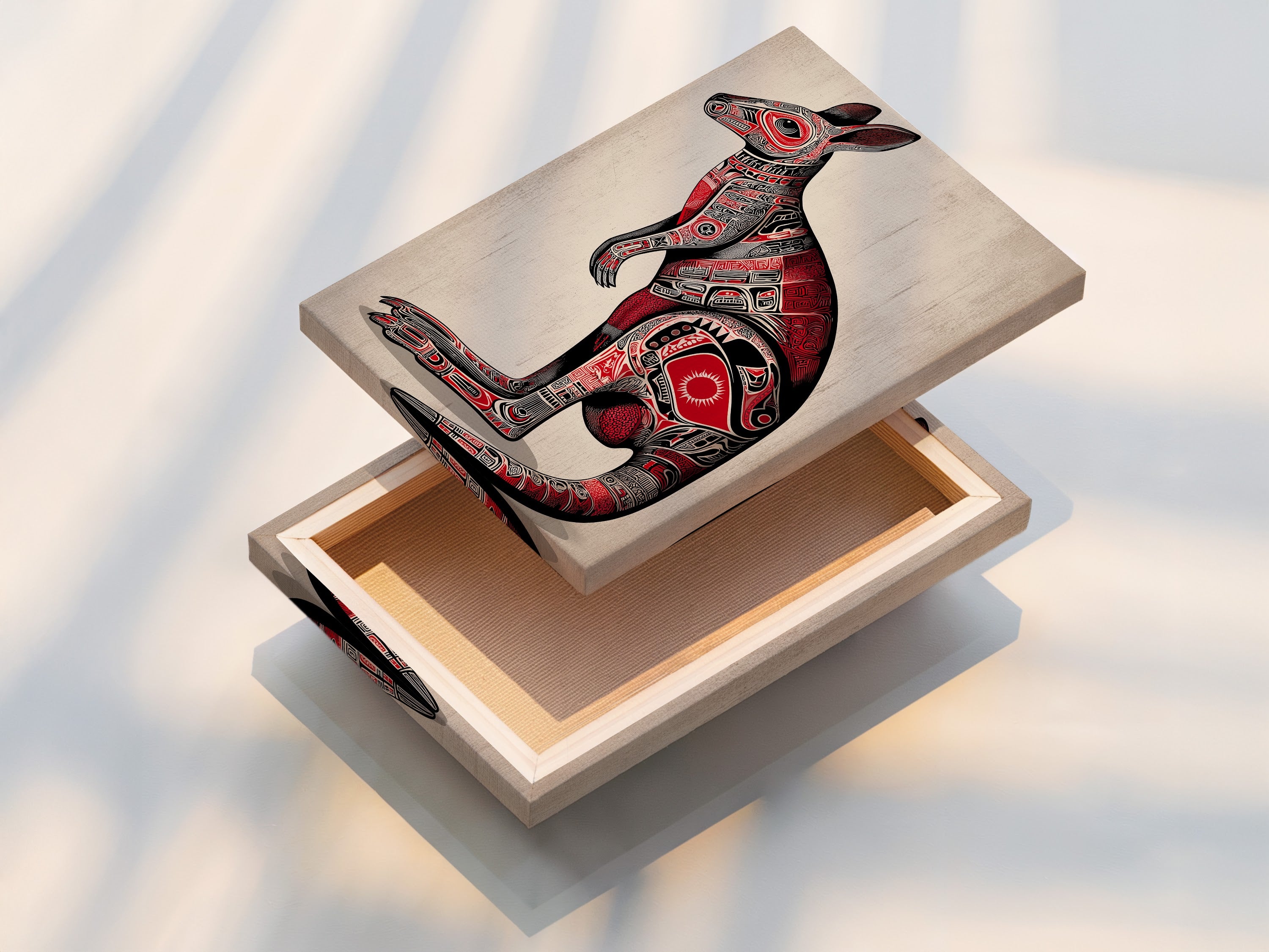 A stretched canvas print of the Aboriginal Kangaroo artwork. The canvas texture enhances the tribal art details. The kangaroo is rendered in vibrant red and black. Ready to hang this piece adds cultural flair to any space. Perfect for bohemian decor.
