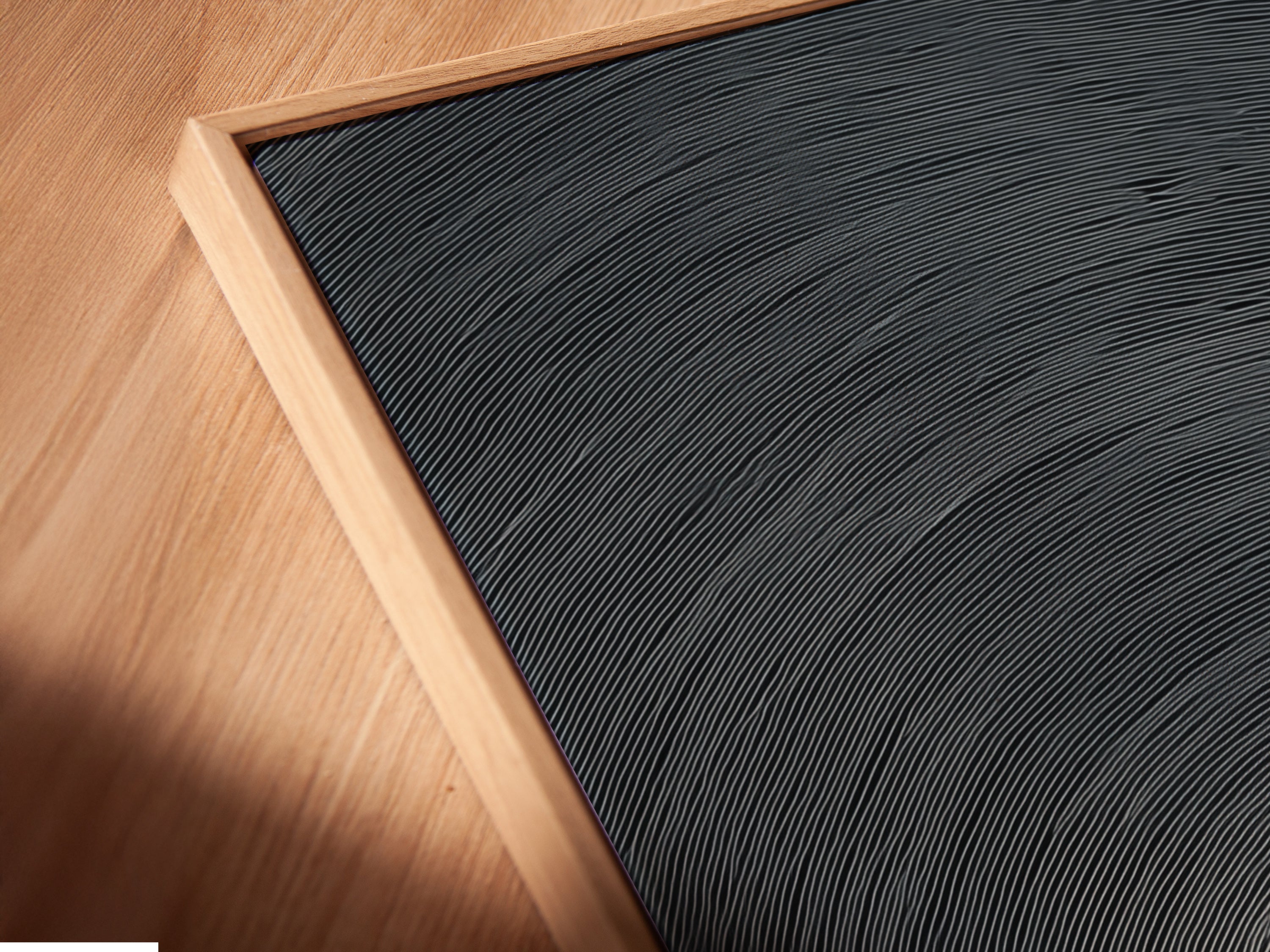 The angled close up reveals a floating frame canvas print. The surreal whale art captures a minimalist ocean scene. Perfect for coastal decor. This unique artwork adds a touch of sophistication to any room. The sunset canvas is captivating.