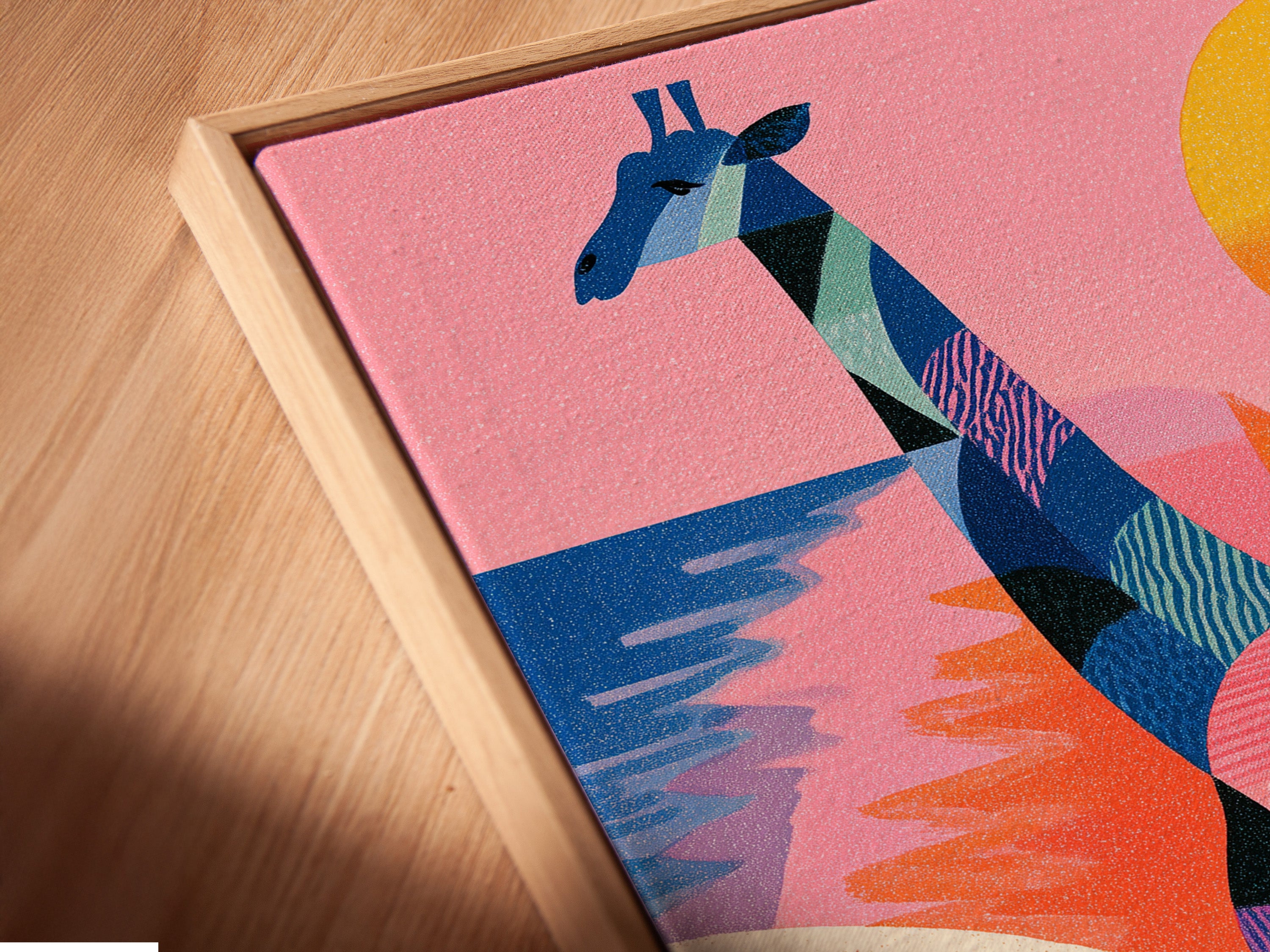 A close-up angled view of a canvas print. It is displayed in a floating frame. This modern frame style is sleek. The artwork features a giraffe a bird and a sunset.