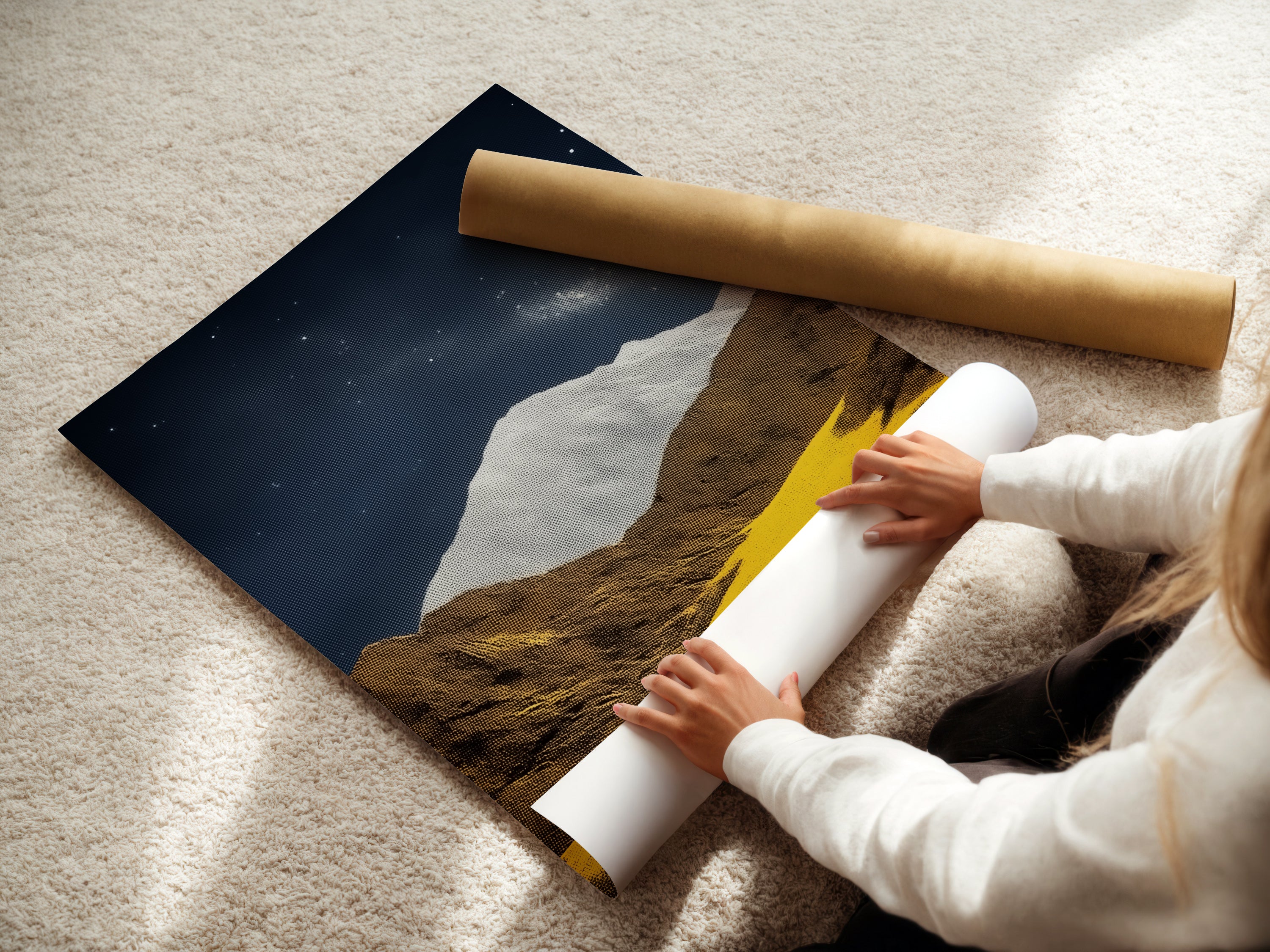 A woman is carefully rolling a fine art poster paper. The paper features the Mountain Galaxy artwork. This print is perfect for creating stunning wall art. The earth tones and celestial details make it ideal for study rooms. This poster adds a touch of modern elegance to any space.