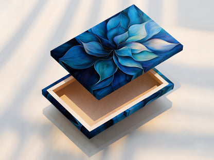 This is a stretched canvas print of a blue flower artwork. The stretched canvas provides a gallery-ready look. This modern floral painting is perfect for creating a focal point. It is ideal for living rooms and offices. The stretched canvas enhances the artwork's contemporary style.