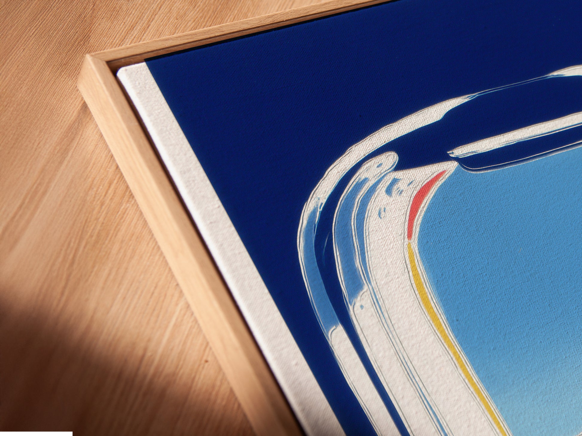 A close-up of a canvas print in a floating frame. The artwork shows an airplane window view with mountains and a blue sky. This modern travel art adds a sophisticated touch. The floating frame enhances the art's appeal.