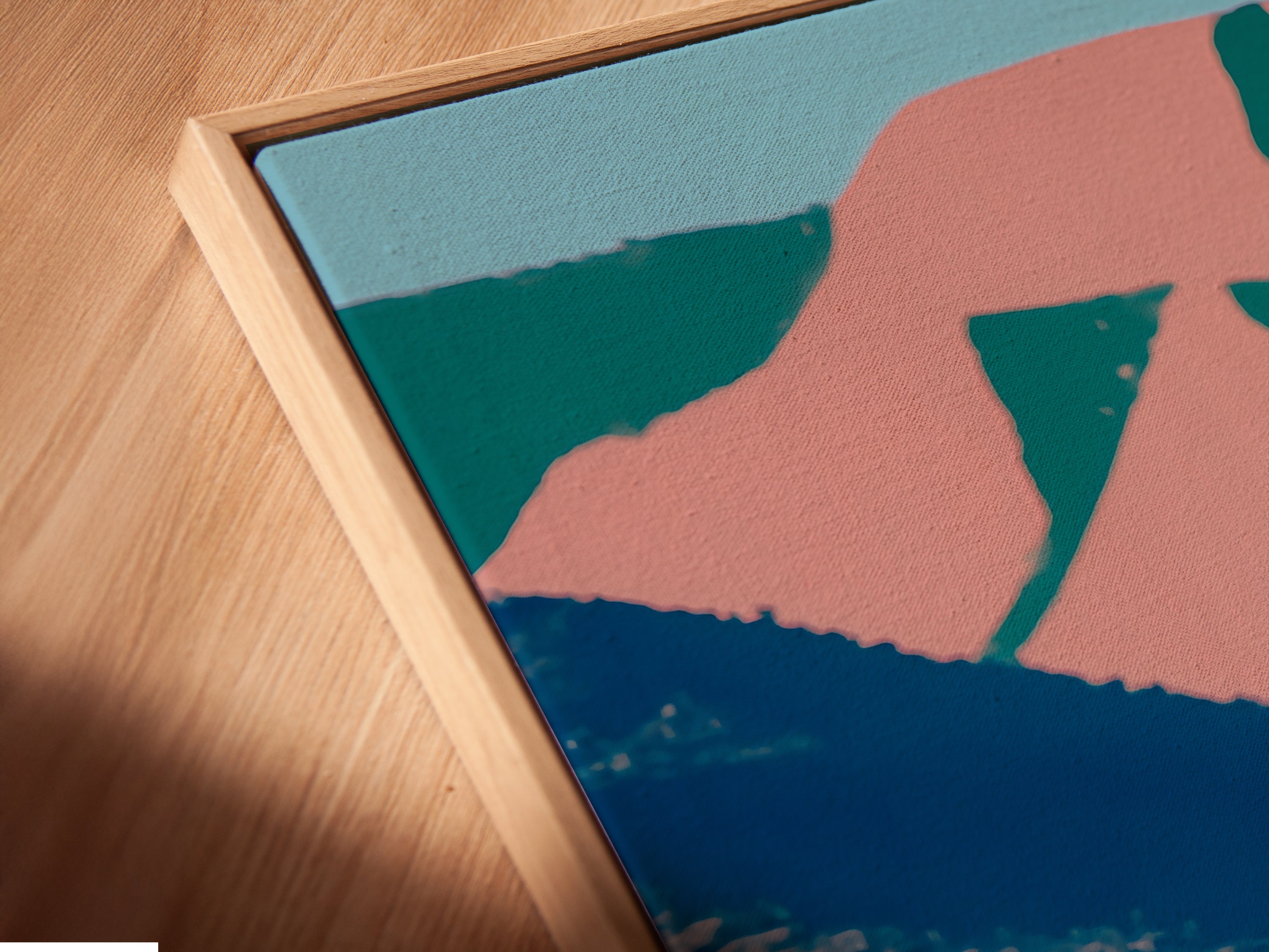 A close-up angled view reveals a canvas print of desert artwork in a floating frame. The industrial landscape features a retro oil pump. The pop art adds style to any room. Perfect for office wall decor or a vintage Americana theme.