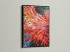 An abstract burst artwork is elegantly framed in black. The vibrant red and orange hues bring energy to the artwork. Its dynamic brushstrokes enhance modern spaces. It will complement minimalist Scandinavian or eclectic styles. Add this bold canvas art to your decor.