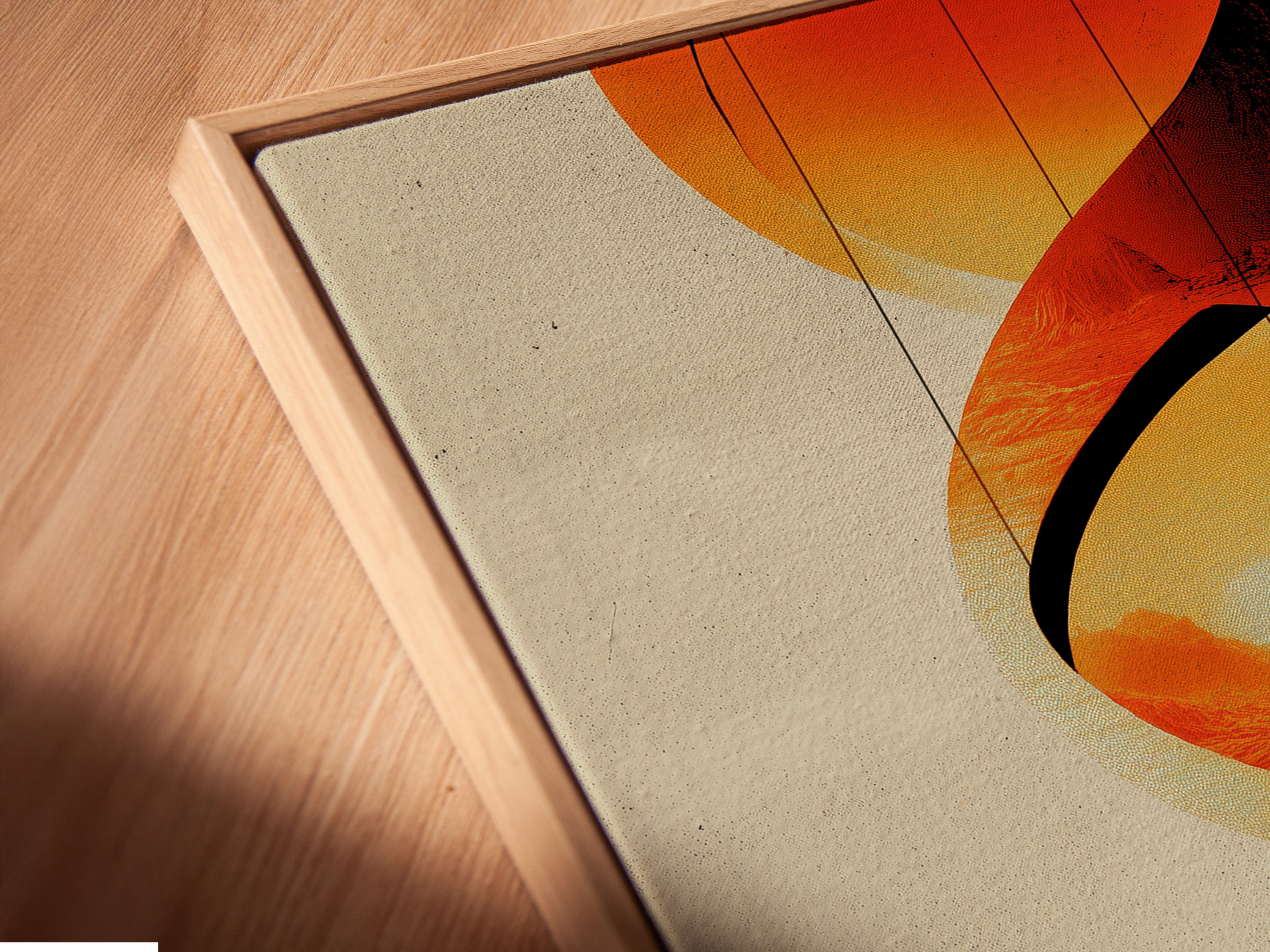 Angled close up of a canvas print in a floating frame. The abstract geometric artwork features orange and red colors. This modern art piece adds depth and style. The floating frame enhances its contemporary look. Ideal for living rooms bedrooms and offices. This art is perfect for minimalist and eclectic styles. A vibrant addition to any wall.