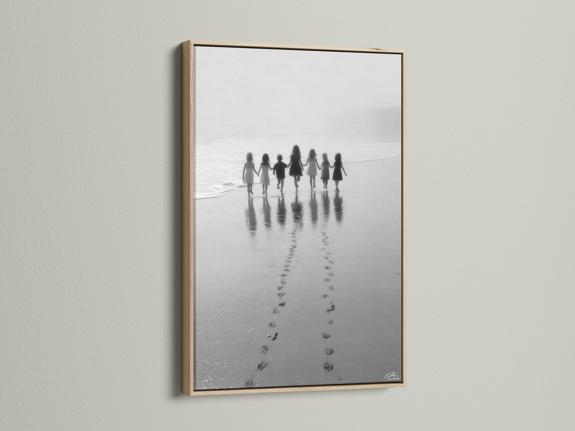 Beach Walk canvas artwork in an oak frame adds warmth to any space. The children print captures a serene black and white seascape. Ideal for nursery decor or a coastal home. This family photo creates a minimalist art statement.