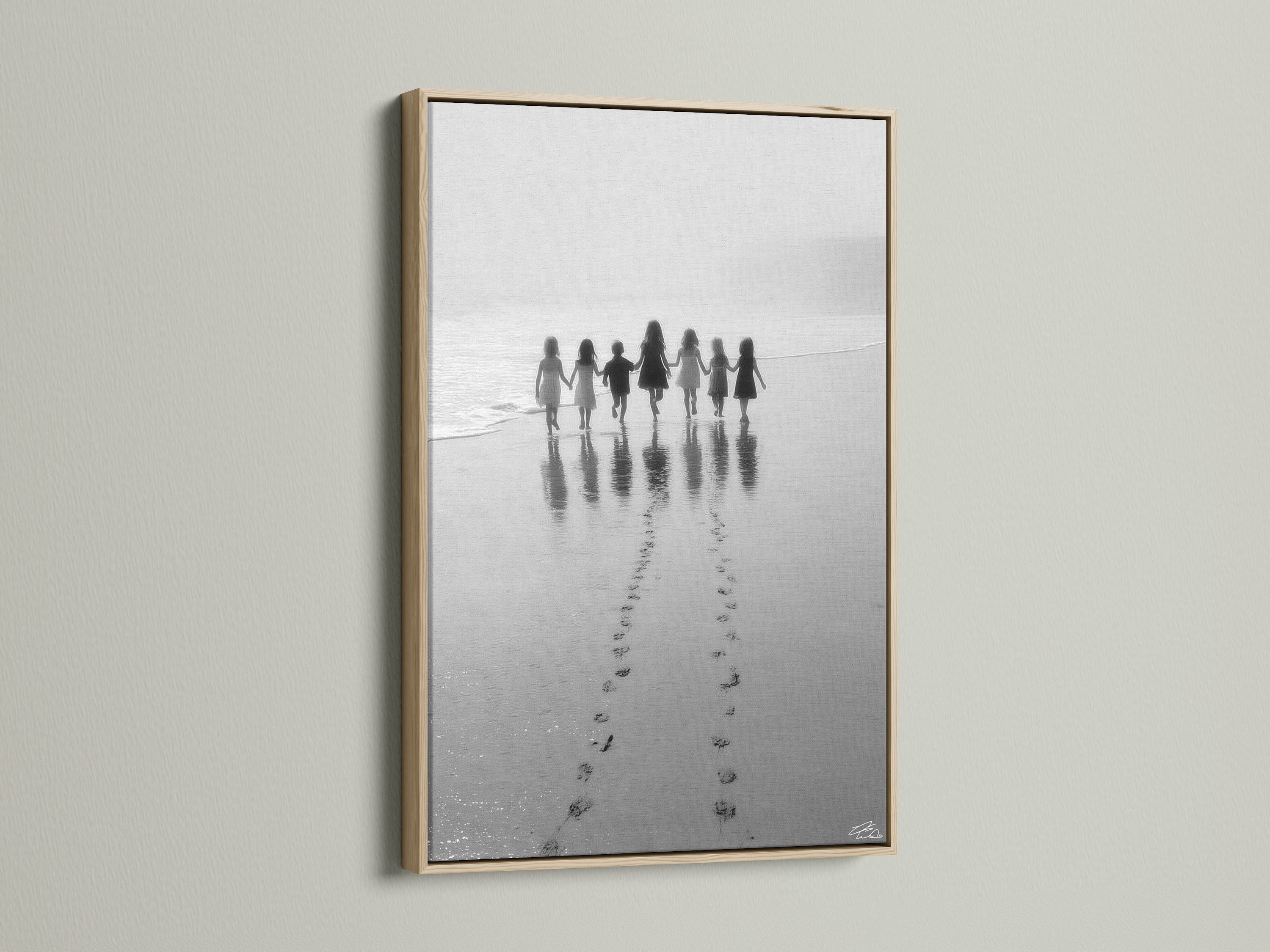 Beach Walk canvas artwork in an oak frame adds warmth to any space. The children print captures a serene black and white seascape. Ideal for nursery decor or a coastal home. This family photo creates a minimalist art statement.