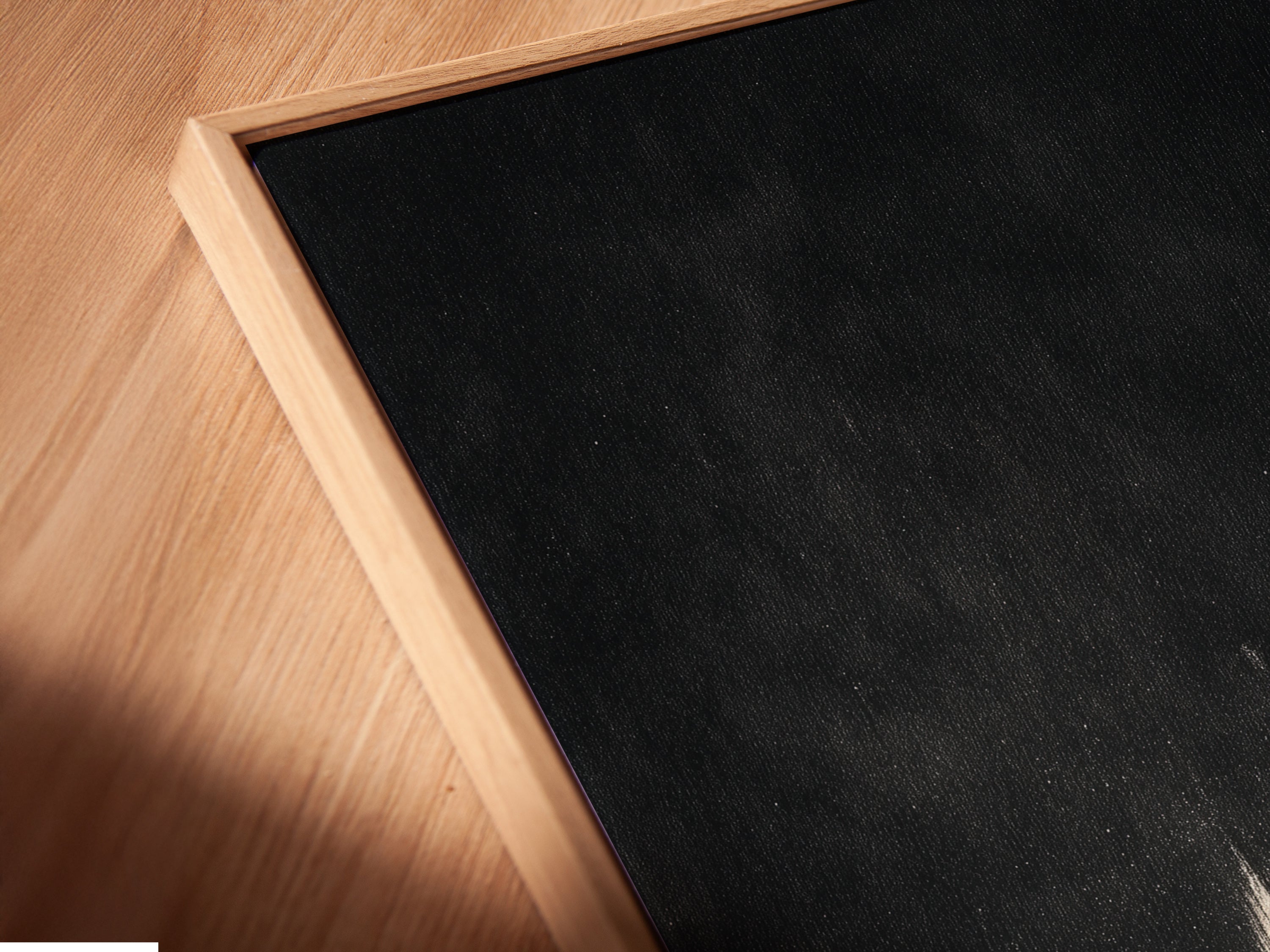 A close-up angled view shows a canvas print in a floating frame. The black and gold art is perfect for modern spaces. The floating frame adds depth to the abstract artwork. This is an excellent choice for contemporary wall decor.