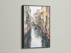 This Venice Canal art is showcased in a black frame. The Italian artwork adds a sophisticated touch to any space. It's perfect for homeowners and apartment dwellers seeking coastal and tropical style decor.