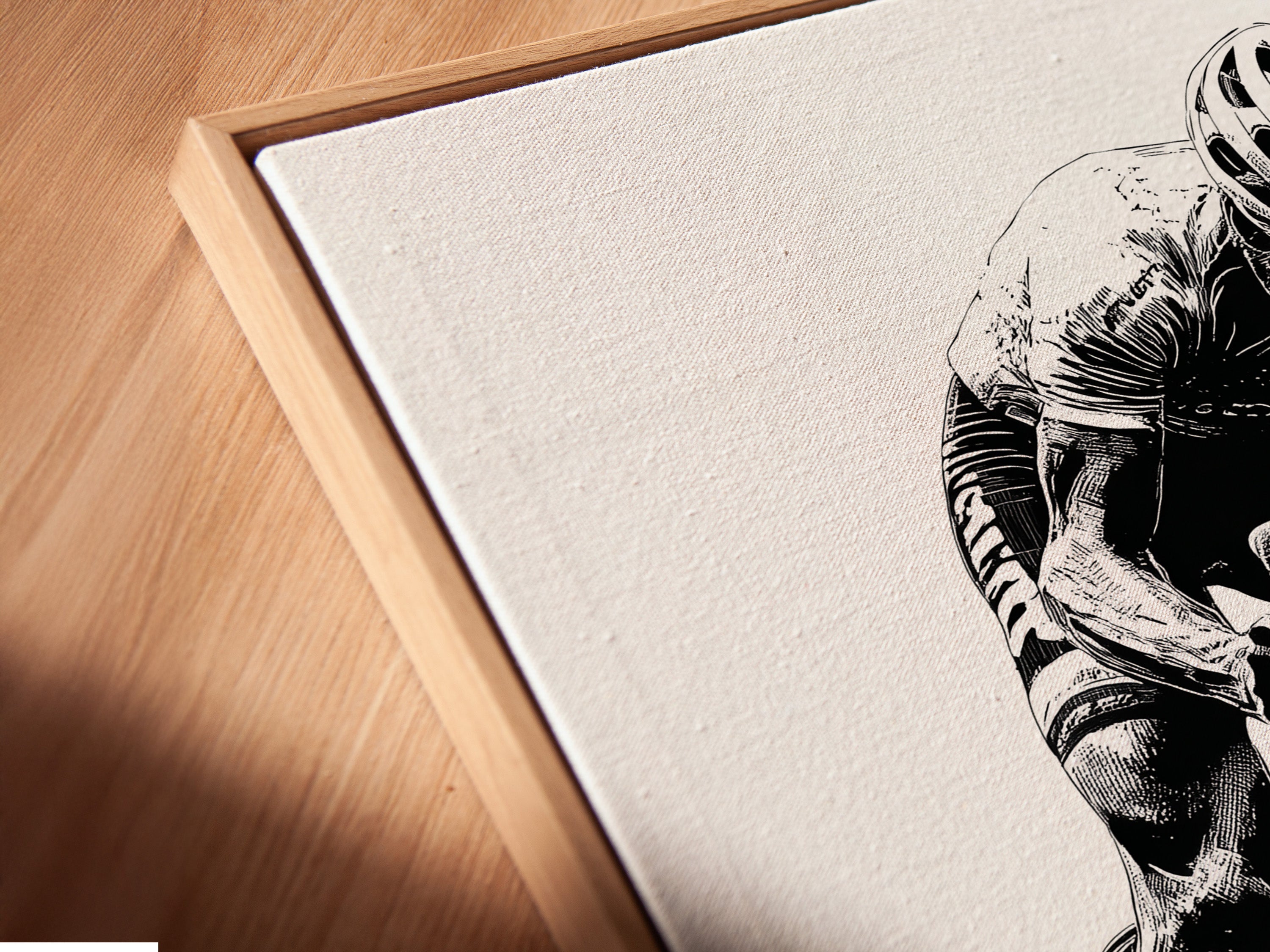 A close-up angled view of a canvas print in a floating frame. This cycling art print is perfect for adding a modern touch to your space. Black and white art complements any decor. Ideal for home gym or office.