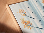 Close-up of a canvas print in a floating frame. This birch tree artwork features a teal forest. The Scandinavian style poster enhances any bedroom. See the details of this beautiful art piece.