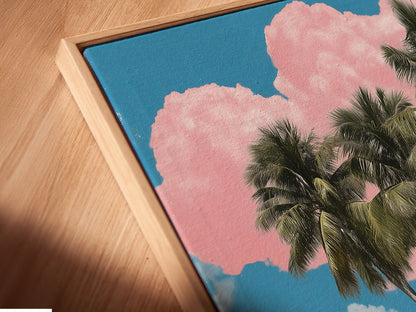 A close up view of our canvas print in a floating frame. The floating frame enhances the artwork. The frame gives it a gallery like appeal. This coastal artwork depicts a tropical island scene. Palm trees and turquoise waters create a serene view.