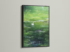 A black frame highlights the artwork. The subject is a swan swimming. The art piece becomes a dramatic focal point. The black frame adds sophistication. It complements various interior styles. The artwork is captivating.