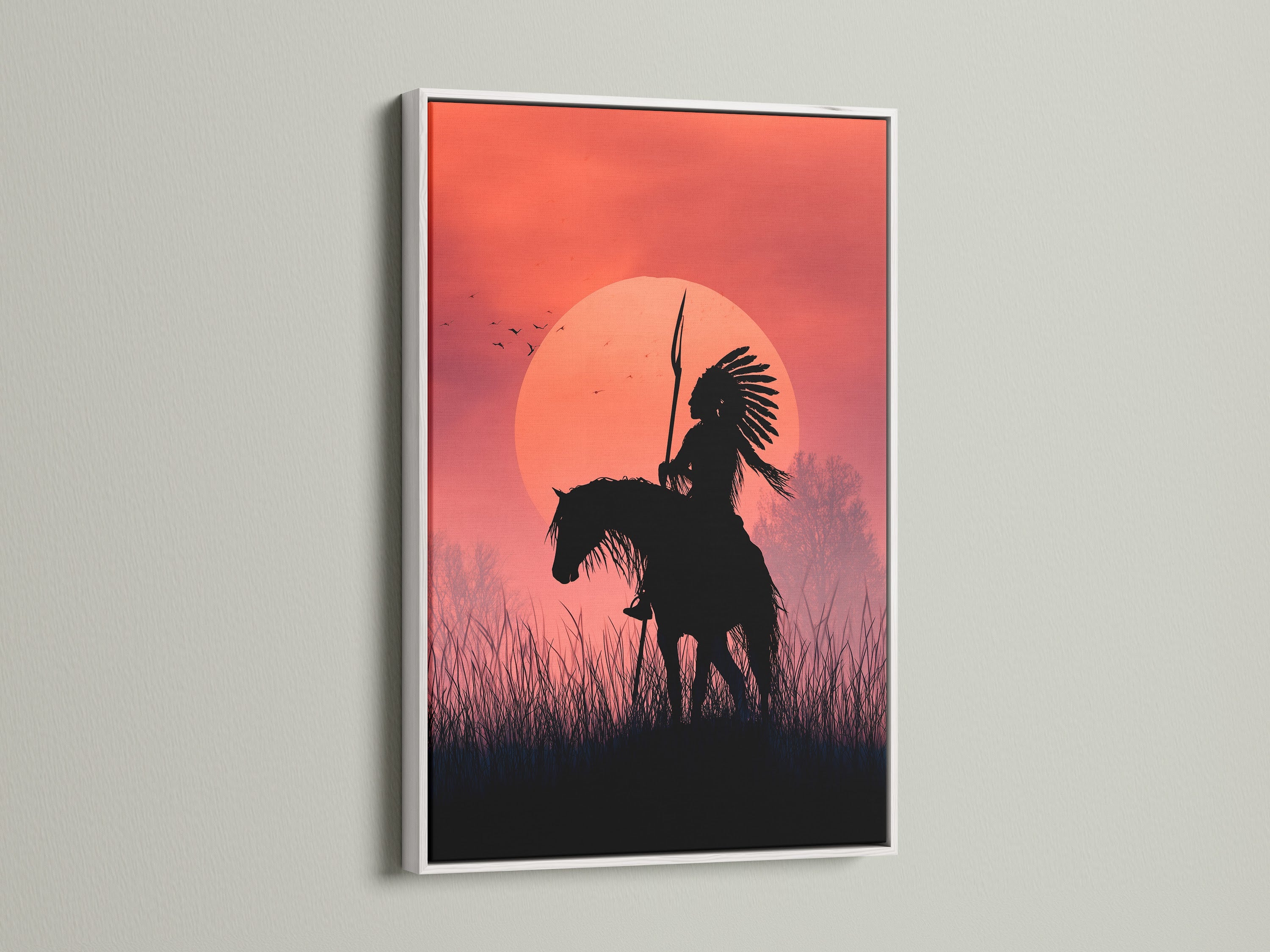 A stunning artwork of an indigenous person on horseback at sunset is displayed in a white frame. The white frame enhances the artwork. It brings a modern touch to any living space. Shop now and elevate your home decor.