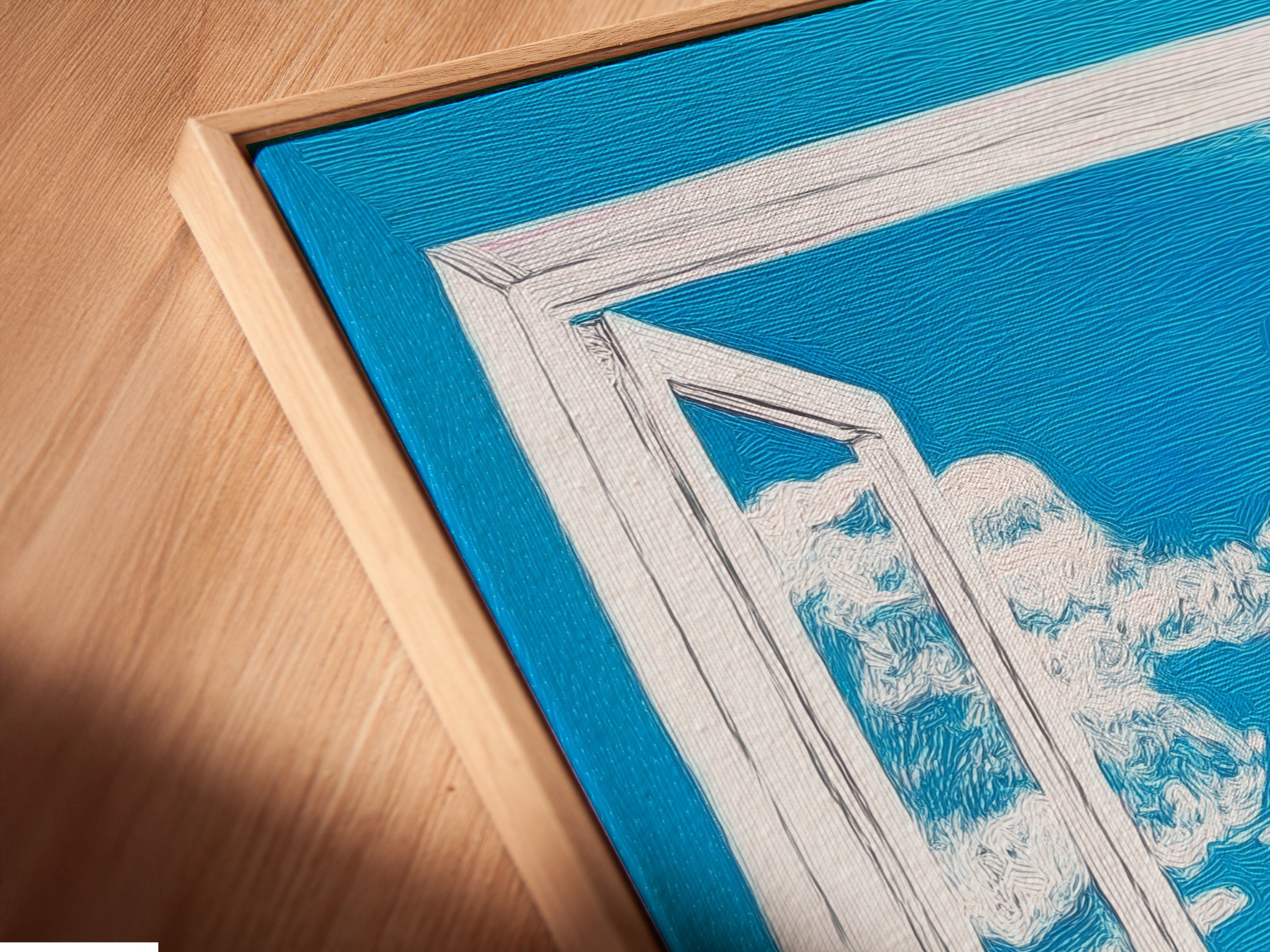 A close-up of a canvas print in a floating frame. The mountain view artwork features a bright blue sky. The open window print adds depth and dimension to the piece. This modern artwork enhances any space. The floating frame creates a sophisticated look.