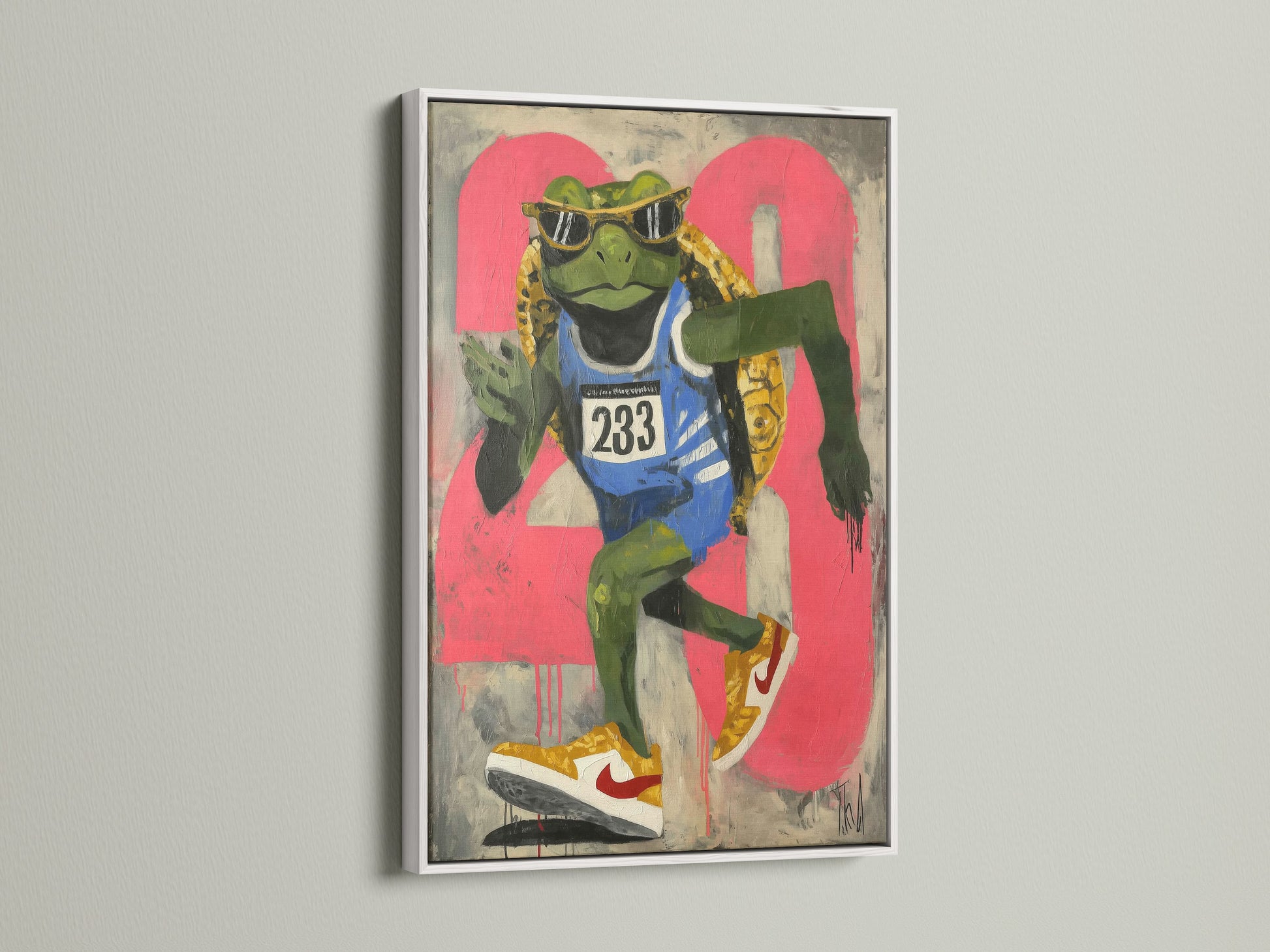A cool animal art print featuring a frog runner is displayed in a white frame. This artwork brings urban street art vibes. It is perfect for teen room decor. It is also great for fitness motivation. This pop art print adds a unique touch to any wall. The primary color is green with pink accents.