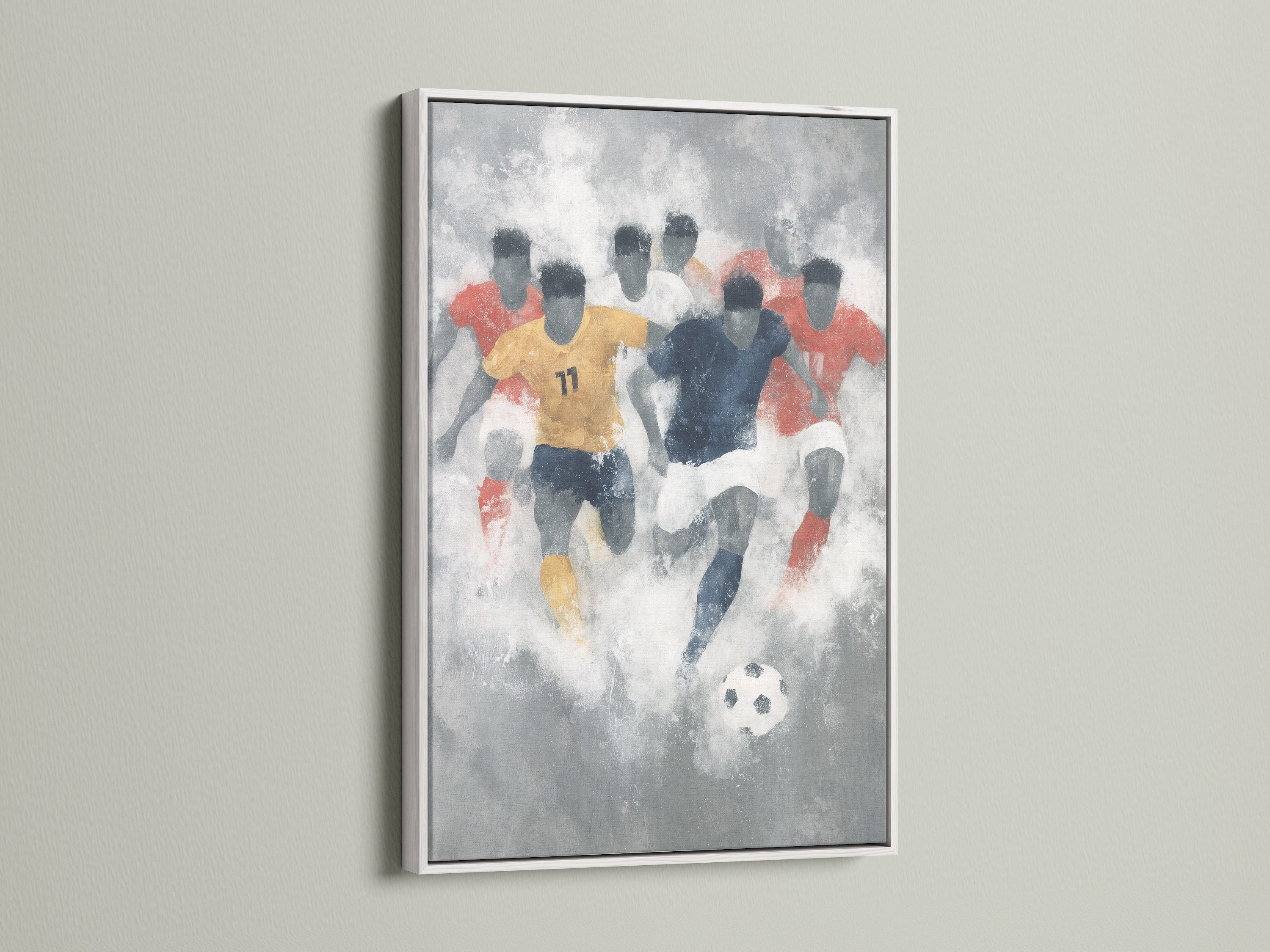 Soccer watercolor wall art presented in a white frame. The artwork showcases an abstract representation of a soccer game. The white frame enhances the sports art print. This is perfect for adding a touch of athletic style to any room. A great gift for a soccer fan.