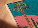 A close-up angled view of a canvas print in a floating frame. The retro Palm Springs artwork showcases a vintage car and desert landscape. The floating frame gives the illusion that the art is floating. This adds a modern touch to the mid-century modern piece.
