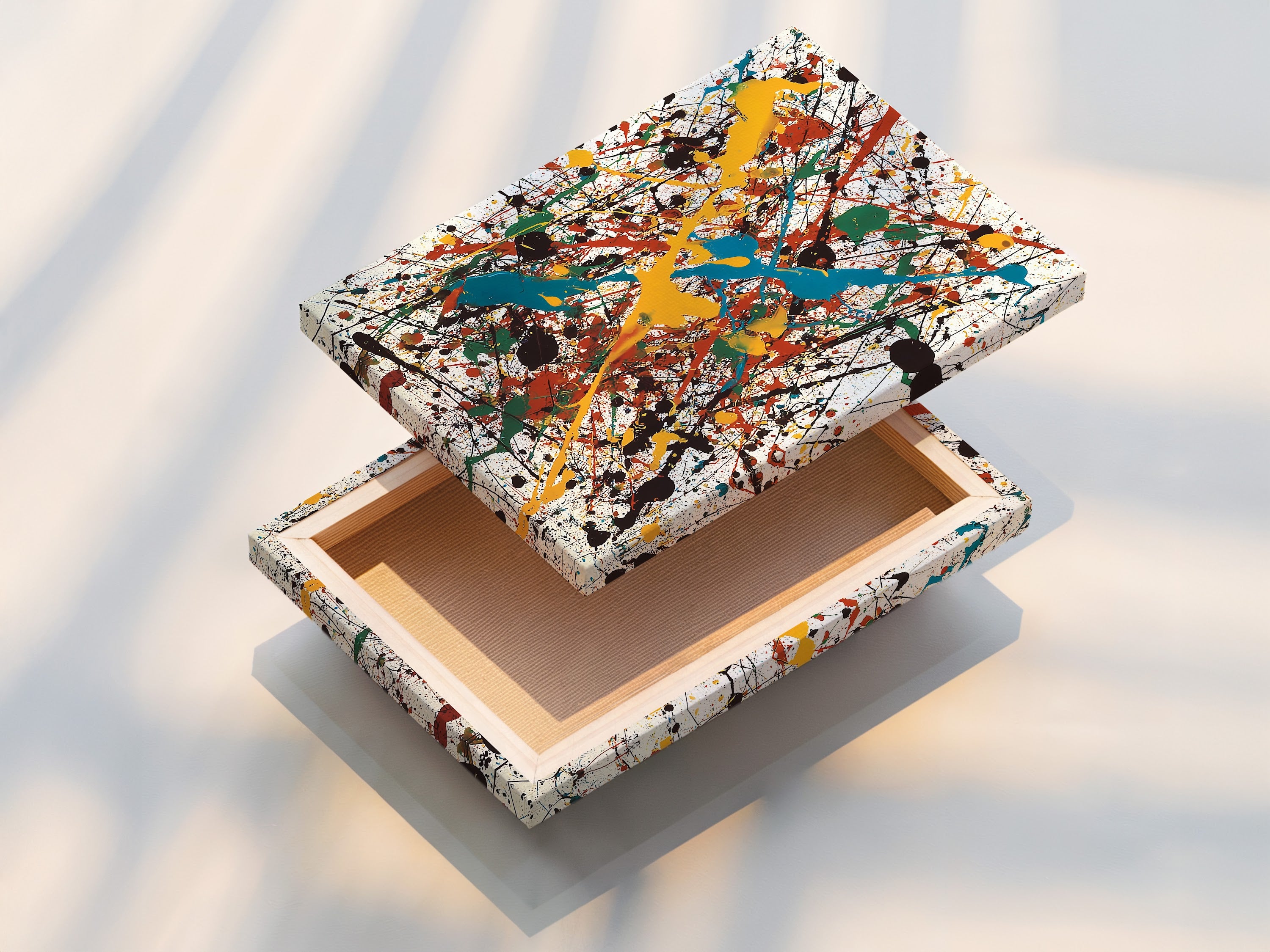 A stretched canvas print is displayed. The canvas provides texture and depth to the artwork. The artwork features splatters of yellow teal red green and black paint. Ready to hang and enjoy in your home or office. Experience the beauty of canvas.