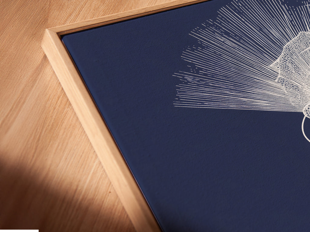 A close-up angled view reveals a canvas print in a floating frame. The frame enhances the artwork's three-dimensional effect. The art piece depicts a woman with a decorative headdress. This framing technique adds depth and sophistication. The floating frame complements the modern artwork.