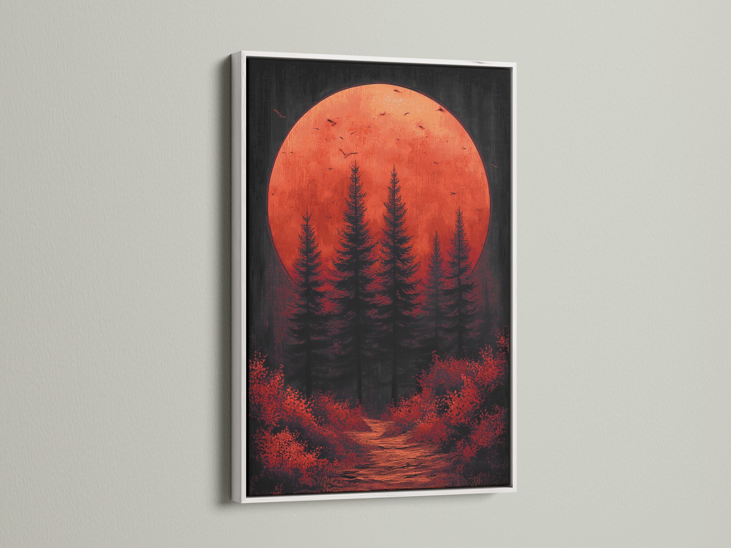 A white frame elegantly holds a forest canvas print. The red orange sunset and moody landscape create a serene atmosphere. This nature canvas art is suitable for a minimalist modern or rustic setting. It enhances bedroom decor.