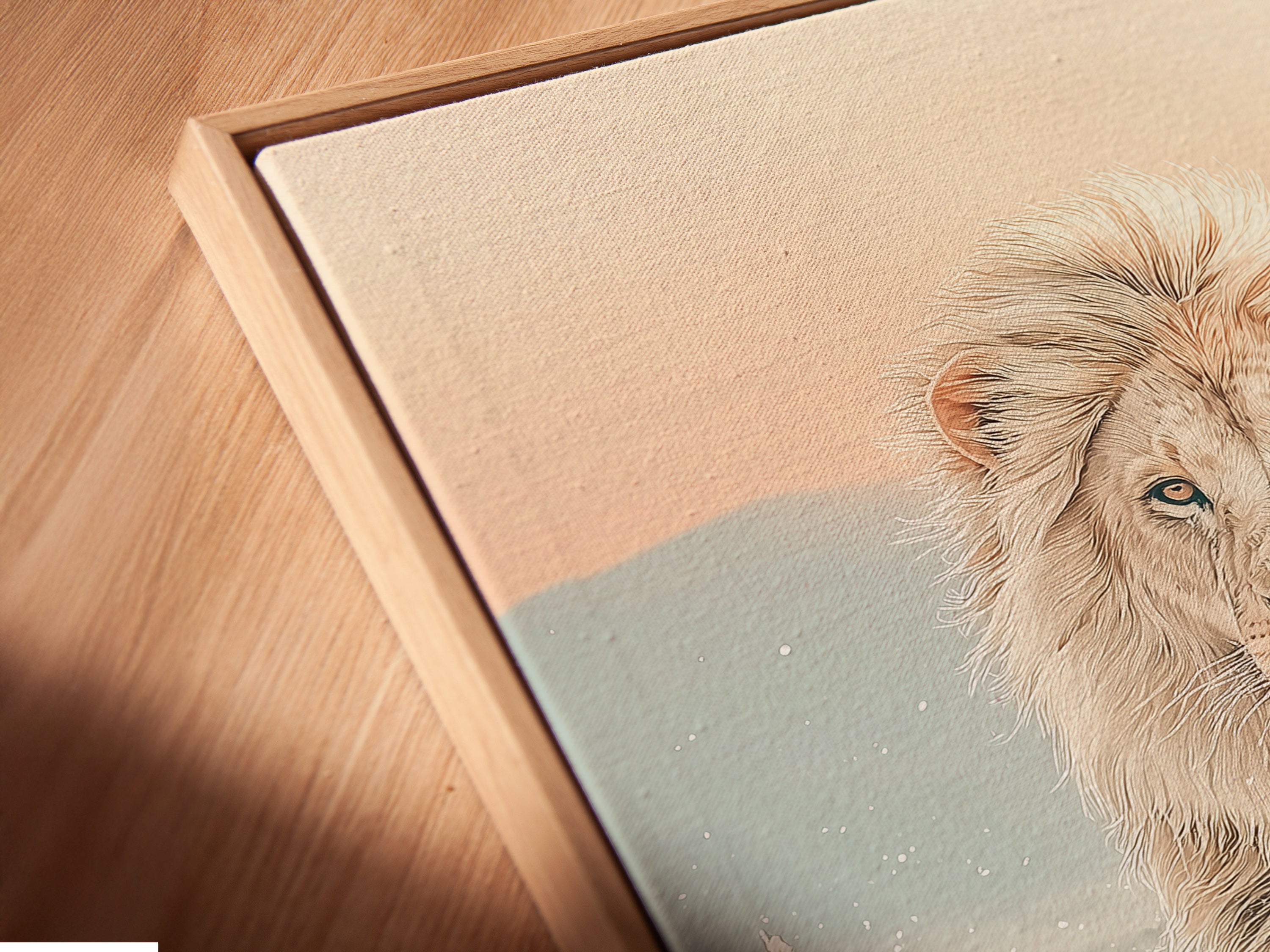 A close up of the lion canvas print in floating frame. The artwork appears to float adding a modern touch to the piece. The wildlife print and neutral tones create a calming atmosphere. Ideal for contemporary wall decor in living rooms or bedrooms. This safari decor is a great addition to any modern home.